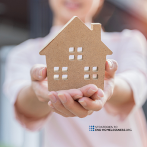 Picture of a Girl Holding a Toy House